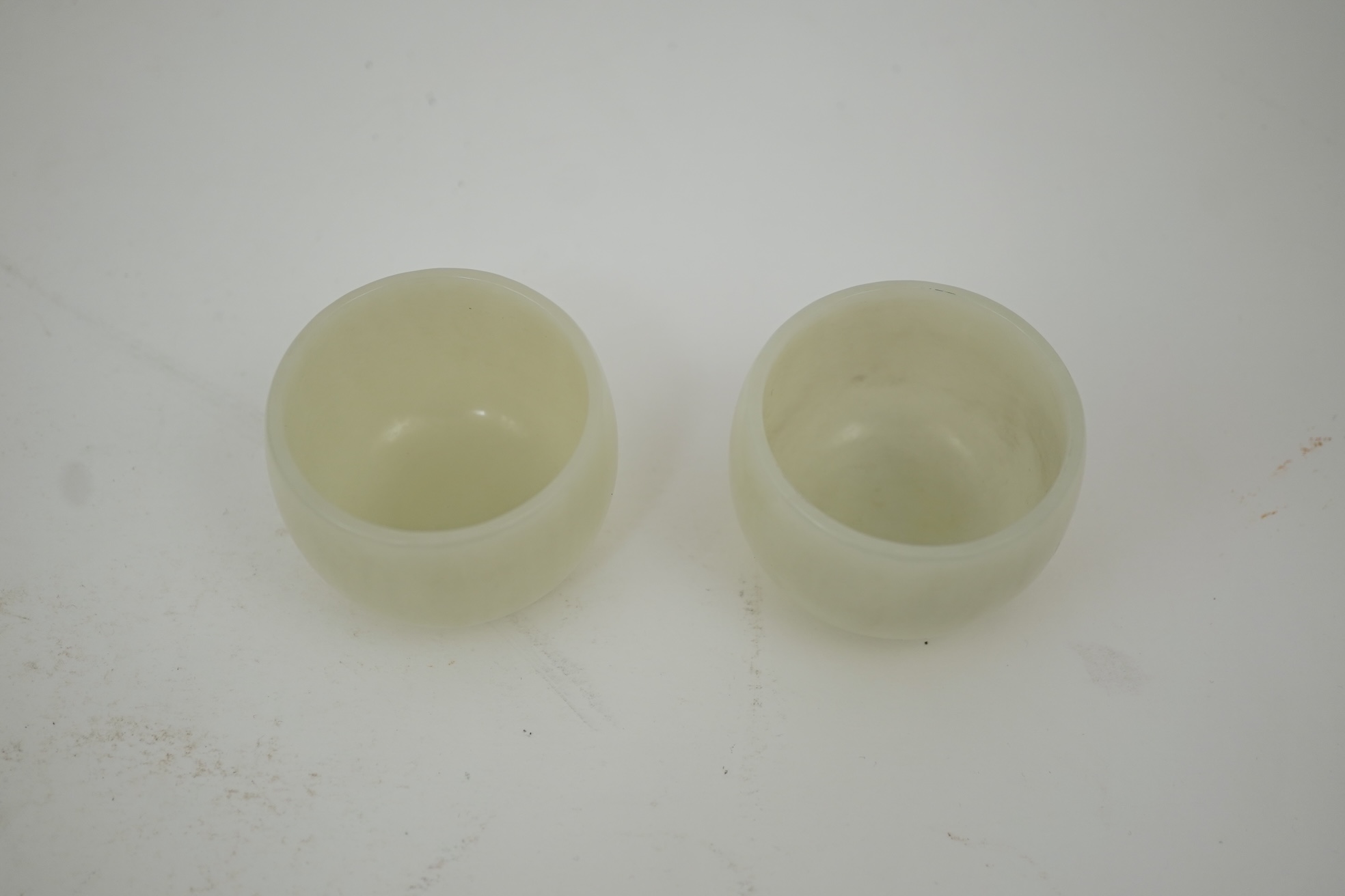 A pair of Chinese white jade cups, Qing dynasty or later